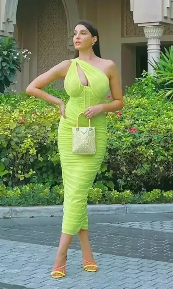 nora fatehi green dress cleavage curvy figure