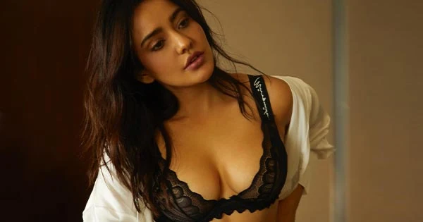 Neha Sharma flaunts ample cleavage in a black lacy bra with matching pants and white shirt – see now.