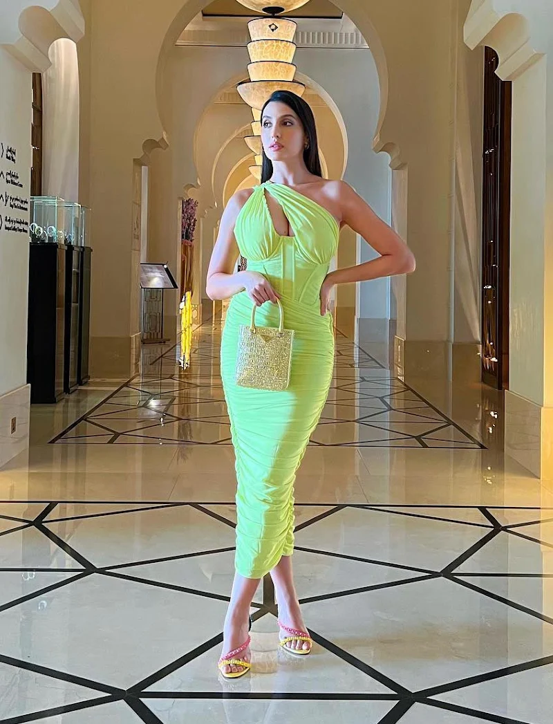 Nora Fatehi cleavage neon green dress