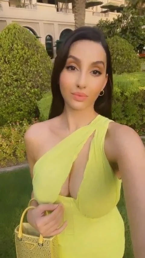 Nora Fatehi cleavage neon green dress