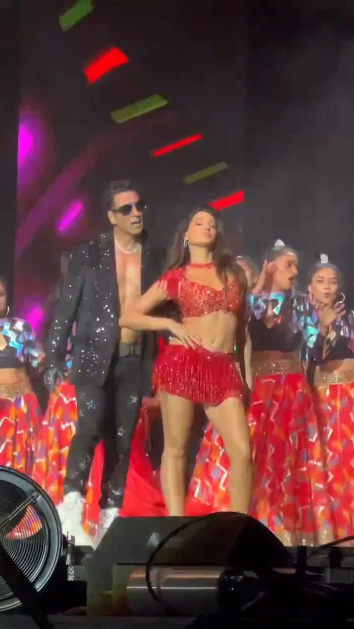 nora fatehi red outfit navel legs tour