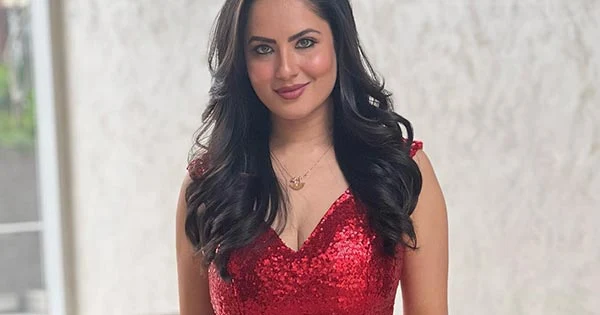 Puja Banerjee in body hugging shimmery red dress with plunging neckline raises the heat – see now.