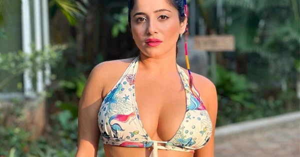 Kate Sharma flaunts ample cleavage and fine curves in this bikini top and short skirt – see now.