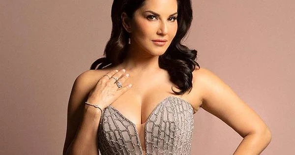 Sunny Leone in this cleavage baring high slit gown posed with hubby – see photos.