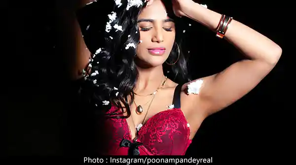 Poonam Pandey in red corset bra did a Christmas photoshoot – see now.